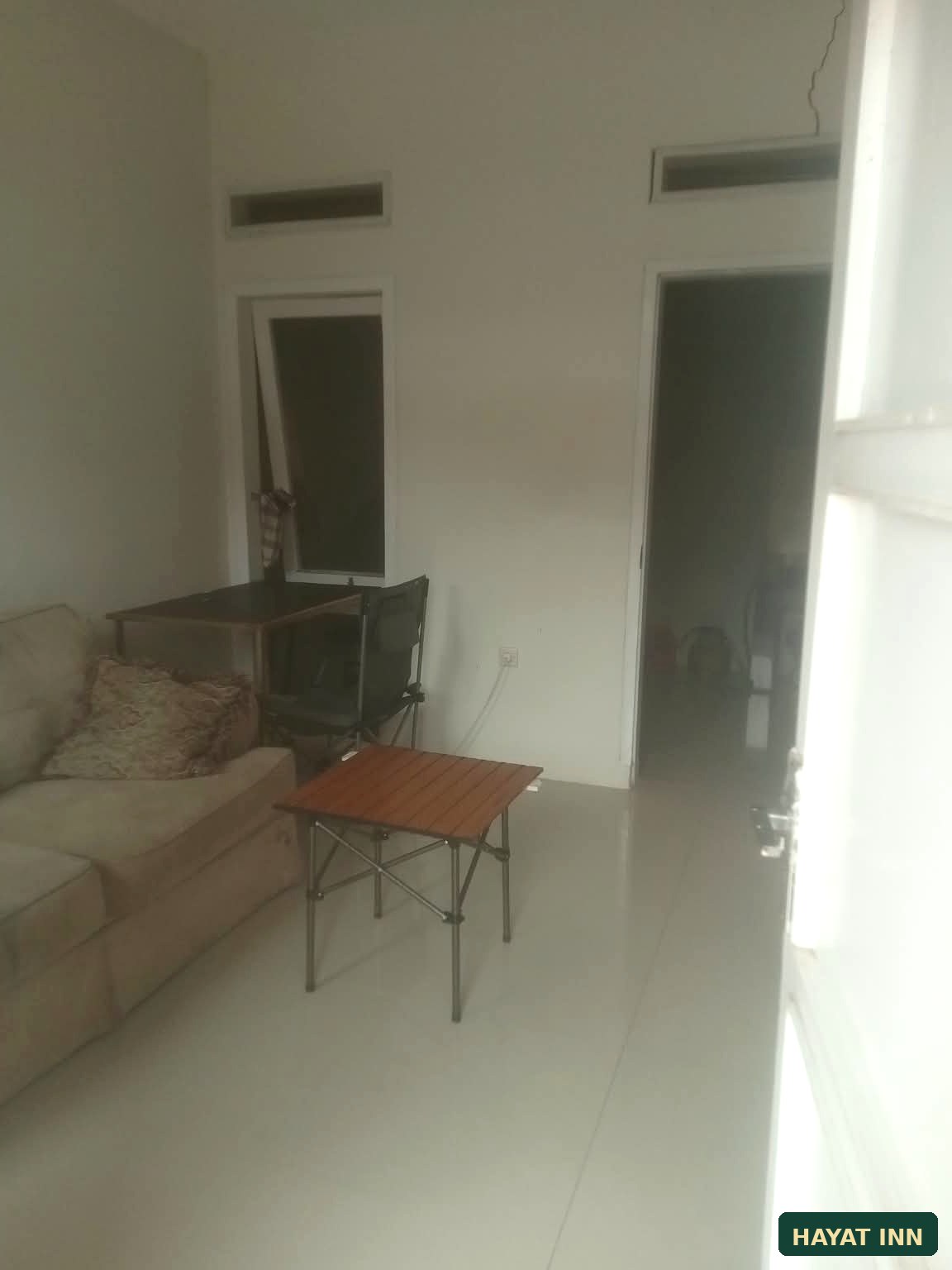 Kamar tidur HAYAT INN dengan tempat tidur dan jendela